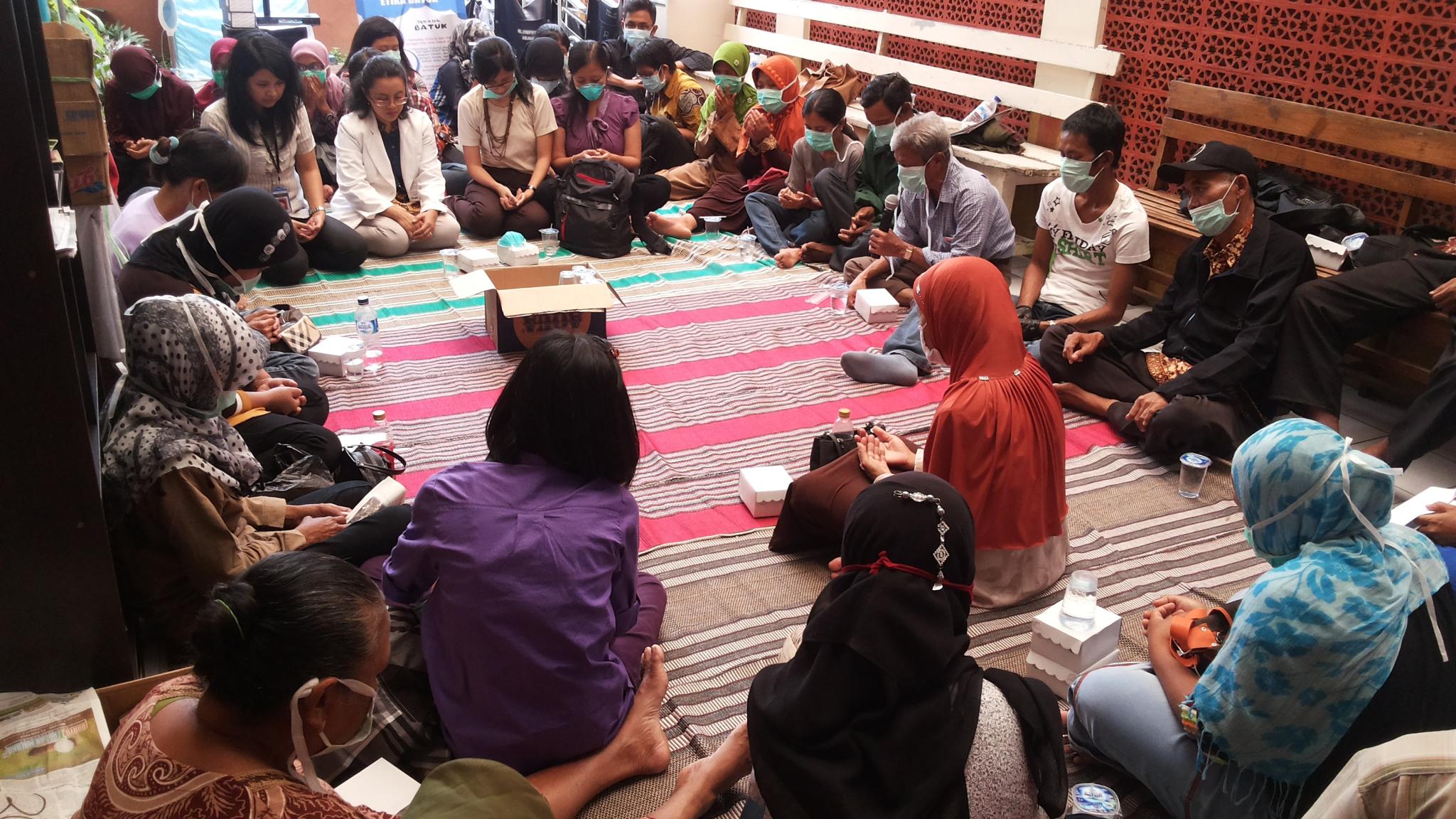 Group of people sitting on the floor. Photo taken in Indonesia.