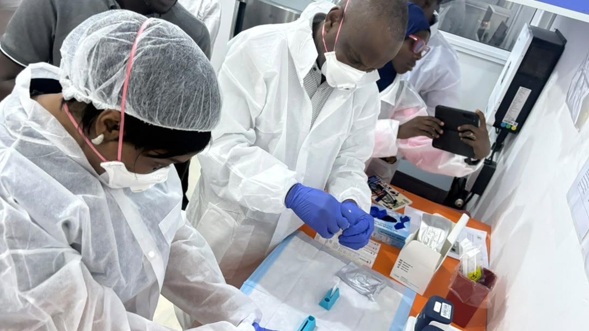 Three men working on a NPOC technology in Nigeria