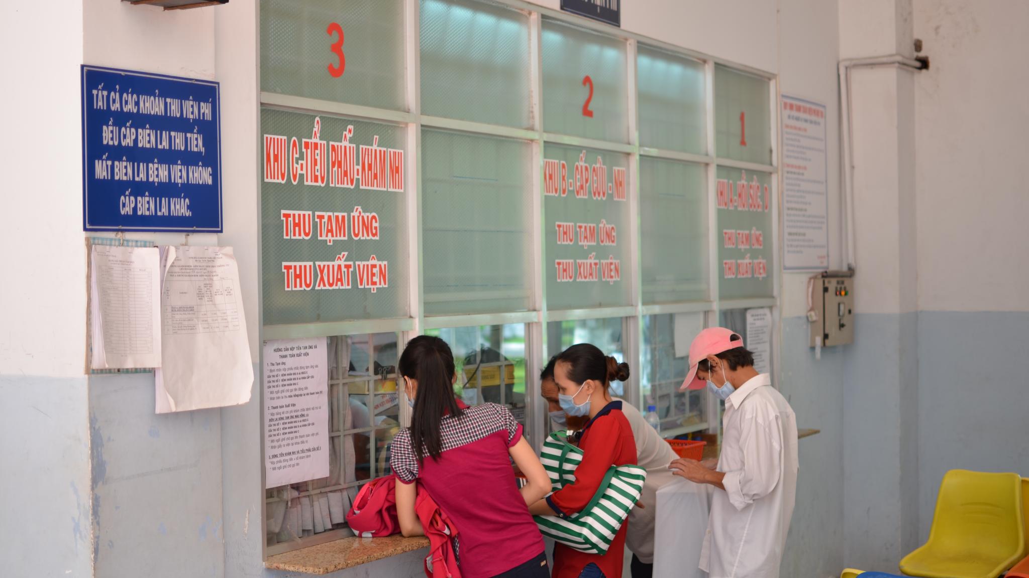 Patients in vietnam at pharmacy window