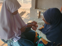 HCW at Bunju Heath Centre reading TB infection test results.