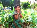 Indonesian kid laughing in the greenery.