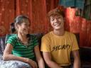 Filipina woman and her son sitting and smiling.