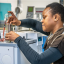 A employee of NIOZ working in the lab with some equipment in hands